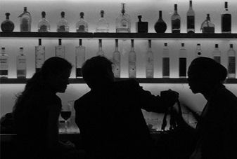 people sitting at a bar greyscale