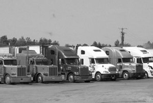 semi-trucks lined up at a truck stop