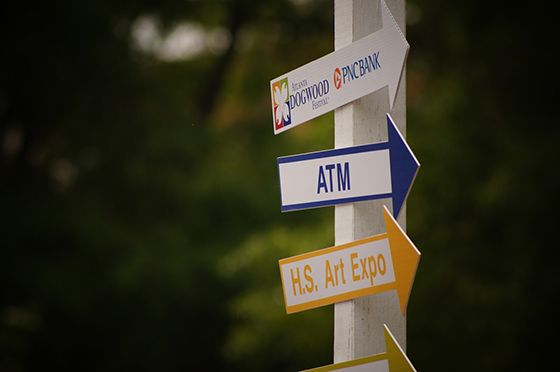 ATM machine arrow sign at outdoor festival