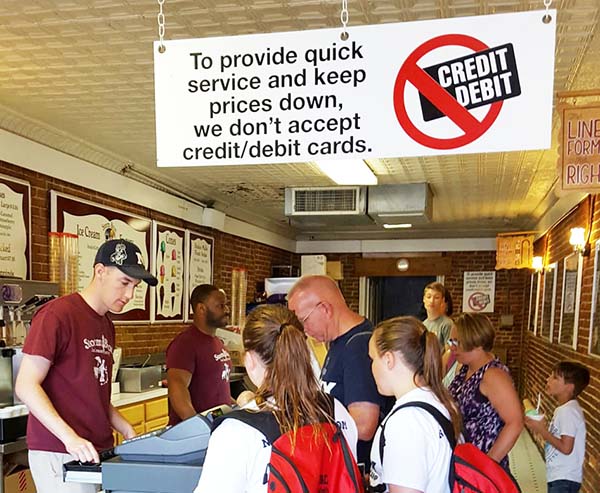 Sign in a store: To provide quick service and keep prices down we don't accept credit/debit cards